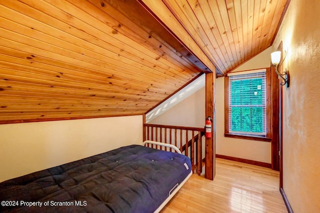 bedroom with lofted ceiling, light hardwood / wood-style floors, and wooden ceiling