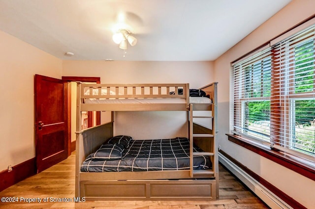 bedroom featuring hardwood / wood-style floors and multiple windows