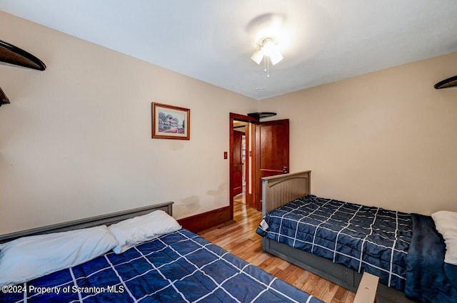 bedroom with hardwood / wood-style floors and ceiling fan