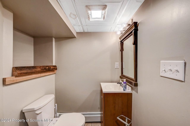 bathroom with vanity, toilet, and baseboard heating