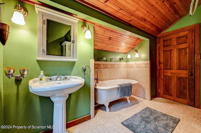 bathroom with a bathing tub, lofted ceiling, sink, and wooden ceiling