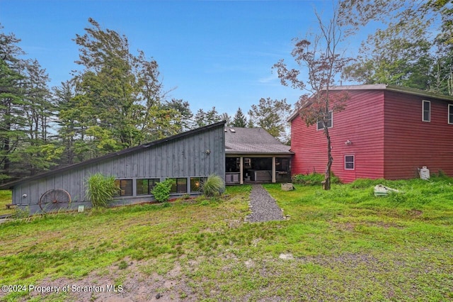 rear view of house with a sunroom