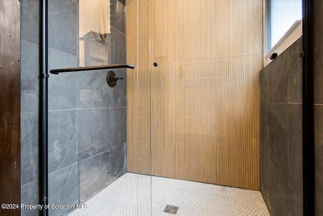 bathroom with tile patterned flooring and walk in shower