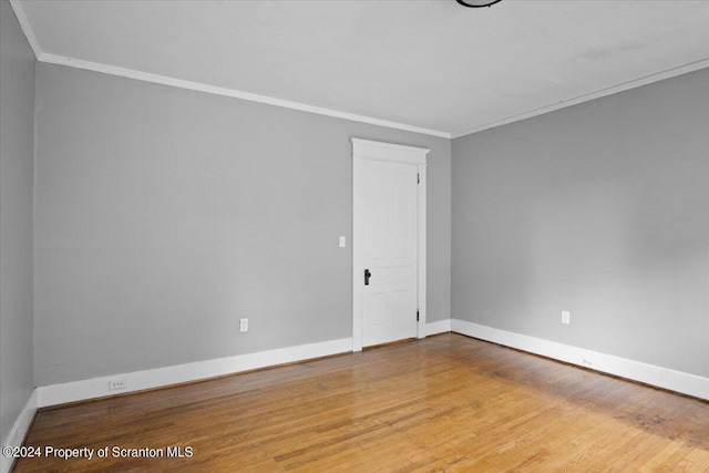 spare room with light hardwood / wood-style flooring and ornamental molding