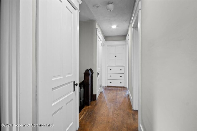 hallway with dark hardwood / wood-style flooring and a textured ceiling