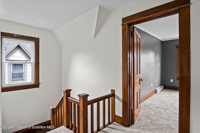 corridor featuring light colored carpet, lofted ceiling, and a baseboard radiator