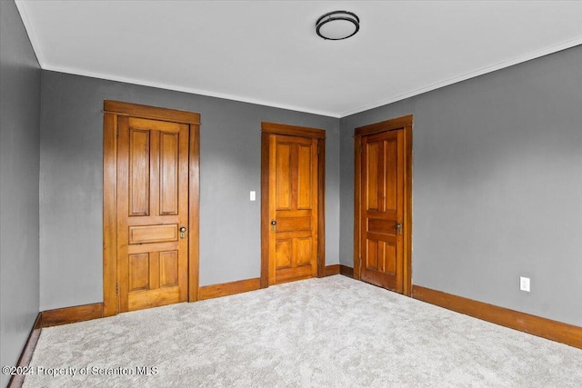 unfurnished bedroom with crown molding and carpet floors