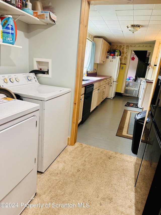 laundry room with separate washer and dryer and sink