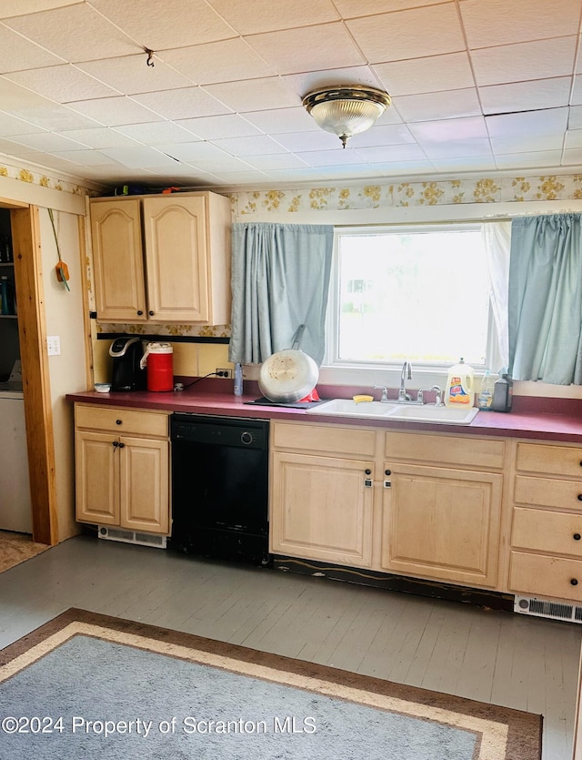 kitchen with washer / dryer, black dishwasher, light brown cabinetry, and sink