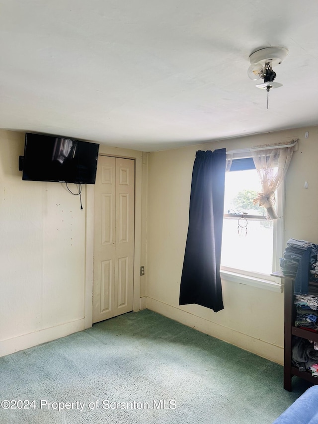 bedroom with carpet and a closet