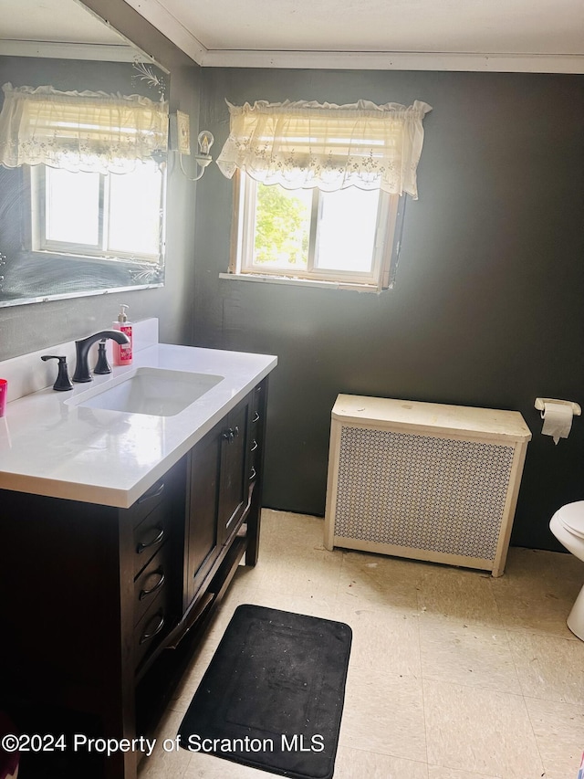 bathroom featuring radiator heating unit, vanity, and toilet