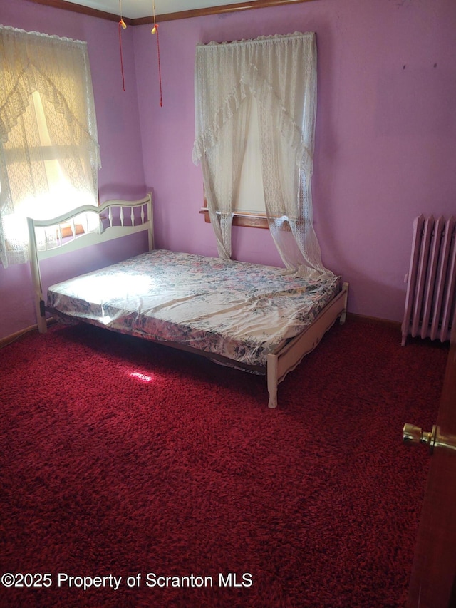 unfurnished bedroom featuring radiator heating unit and carpet