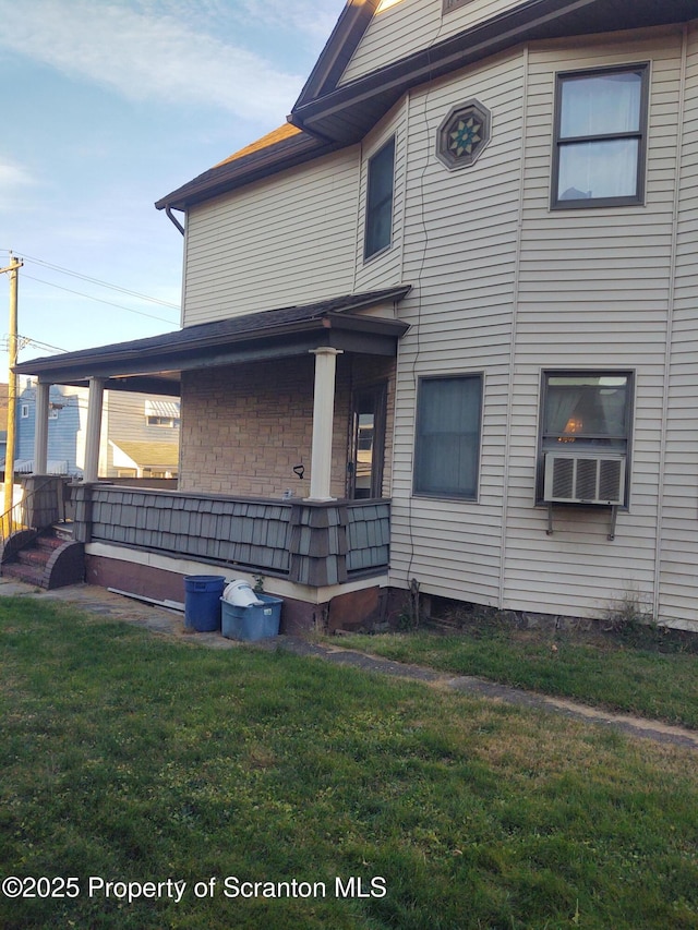 view of front of property with a front yard and cooling unit