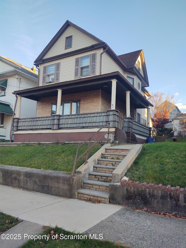 view of front of house with covered porch and a front yard