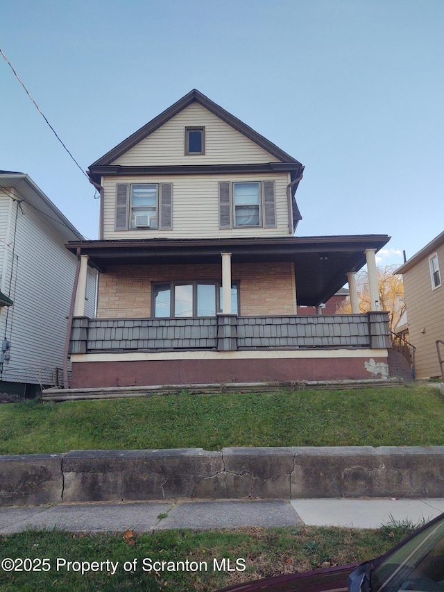 view of front of home with a front lawn and a porch