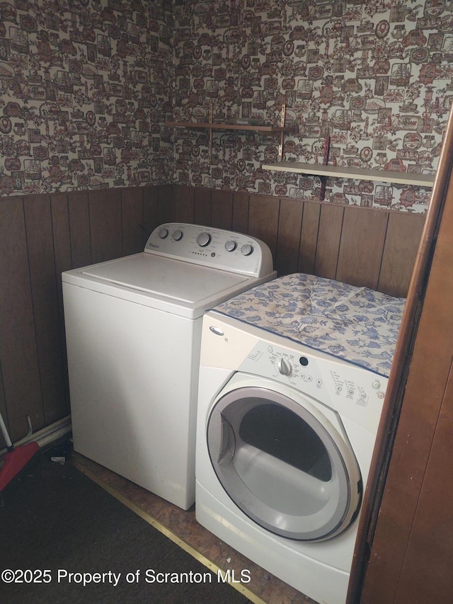 clothes washing area featuring laundry area and washing machine and clothes dryer