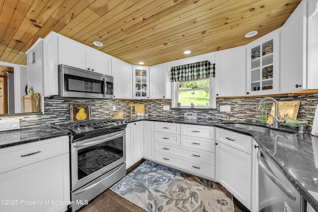 1715 Booth Rd, Hallstead, PA 18822 - kitchen with appliances with stainless steel finishes, wooden ceiling, dark stone counters, white cabinets, and glass insert cabinets