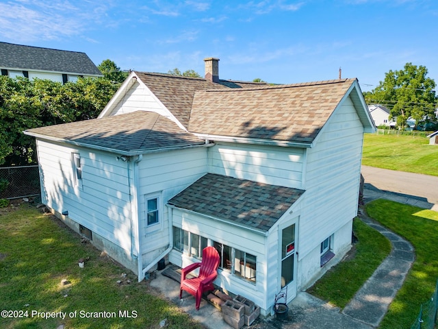 rear view of house with a lawn