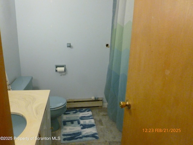 full bathroom featuring toilet, a baseboard heating unit, and vanity