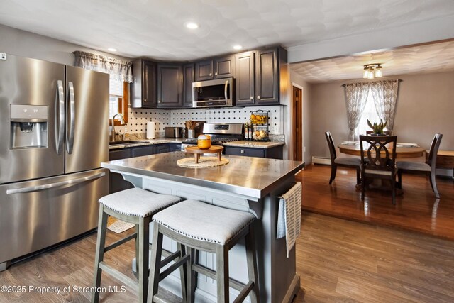 217 N Everett Ave, Scranton, PA 18504 - kitchen featuring a kitchen bar, appliances with stainless steel finishes, wood finished floors, and a sink