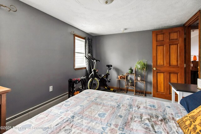 217 N Everett Ave, Scranton, PA 18504 - bedroom featuring baseboards, a baseboard heating unit, and a textured ceiling