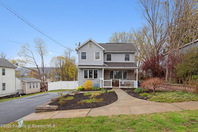 217 N Everett Ave, Scranton, PA 18504 - traditional-style home with aphalt driveway, roof with shingles, fence, and covered porch