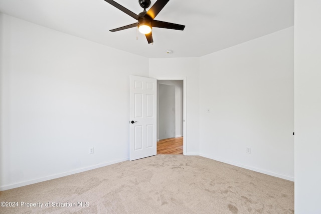 carpeted empty room with ceiling fan