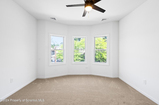 spare room featuring carpet floors and ceiling fan