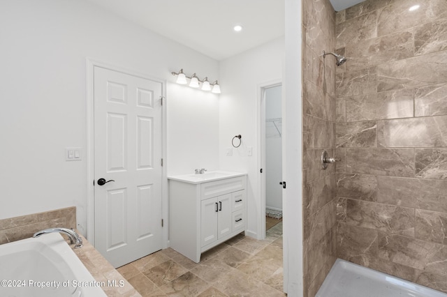 bathroom with vanity and independent shower and bath