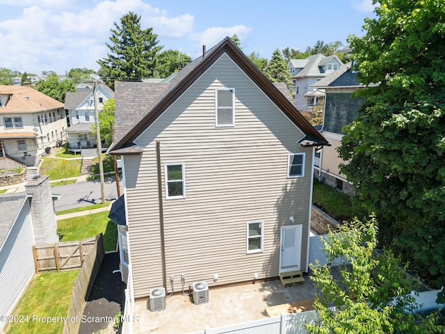 view of side of home featuring central AC