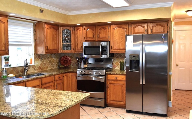 548 Winter St, Old Forge, PA 18518 - kitchen with stainless steel appliances, light tile patterned floors, stone countertops, and brown cabinets