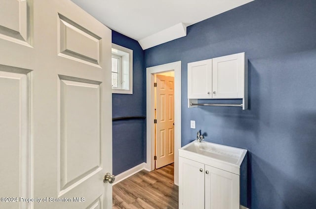 interior space with sink and hardwood / wood-style flooring