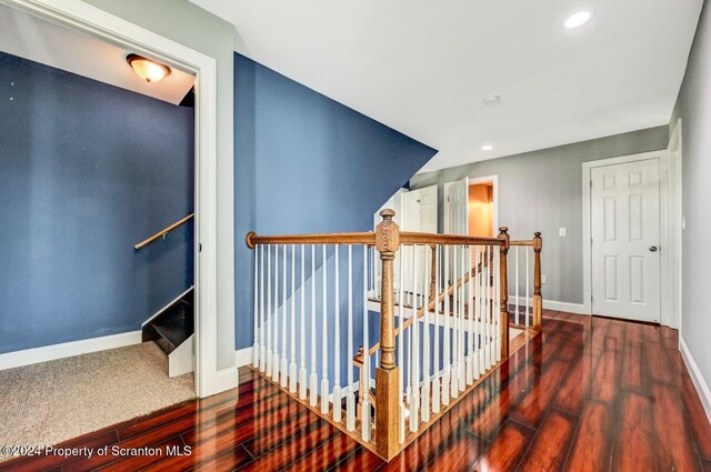 staircase with hardwood / wood-style flooring