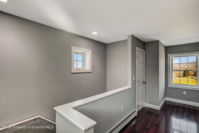 hall featuring baseboard heating and dark wood-type flooring