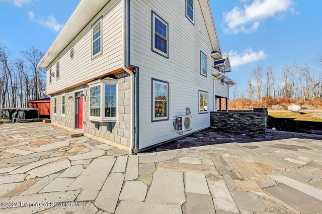 view of home's exterior with ac unit and a patio area