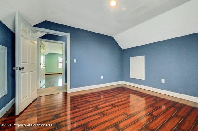 additional living space with baseboard heating and vaulted ceiling