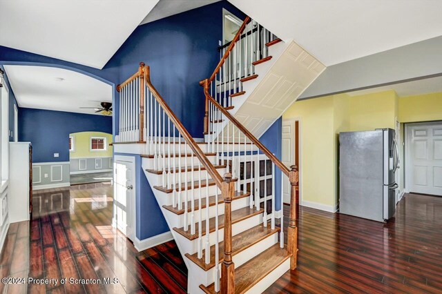 stairway with ceiling fan and hardwood / wood-style flooring