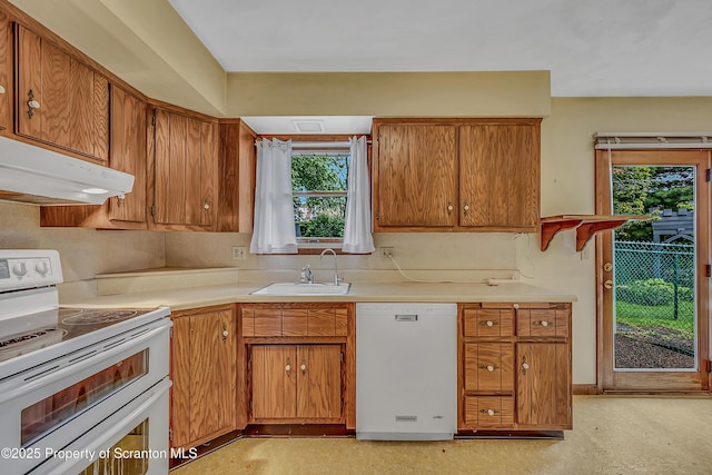 512 Thomas Dr, Dunmore, PA 18512 - kitchen featuring white appliances, under cabinet range hood, healthy amount of natural light, and light countertops