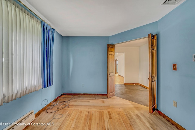 512 Thomas Dr, Dunmore, PA 18512 - empty room with baseboard heating and hardwood / wood-style flooring