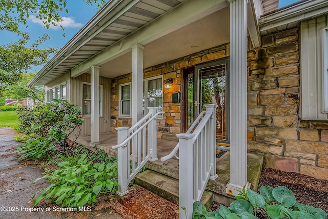 512 Thomas Dr, Dunmore, PA 18512 - view of exterior entry featuring stone siding and covered porch