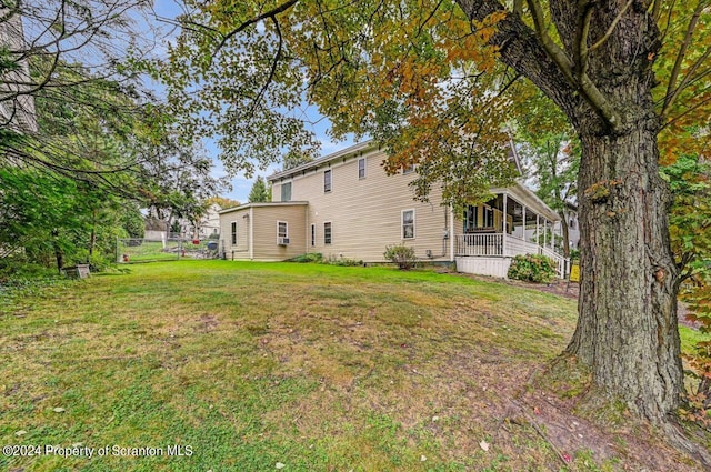 back of house featuring a yard