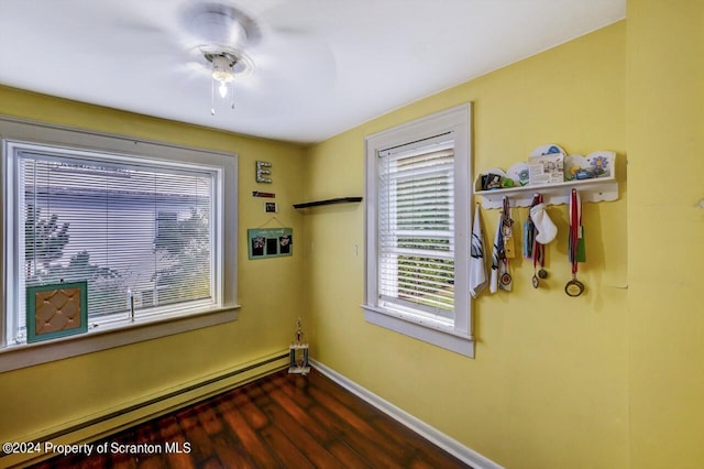 interior space with baseboard heating and dark wood-type flooring