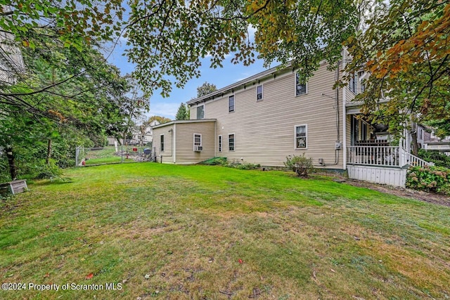 rear view of property with a lawn