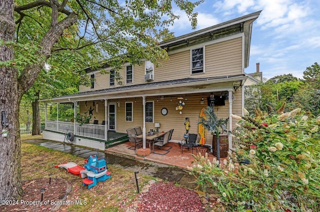 view of front of house featuring a porch and a patio area