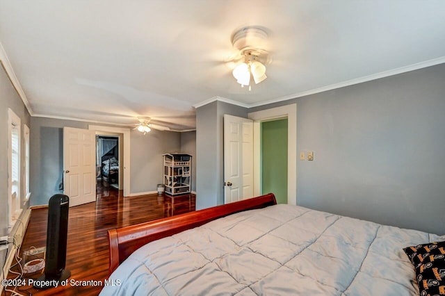 bedroom with dark hardwood / wood-style floors, ceiling fan, and crown molding