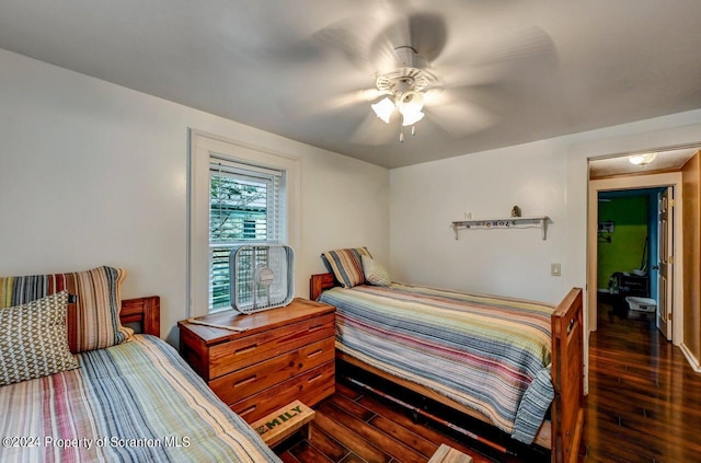 bedroom with ceiling fan and dark hardwood / wood-style floors