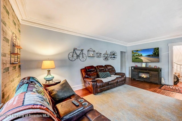 living room featuring a fireplace, wood-type flooring, and ornamental molding