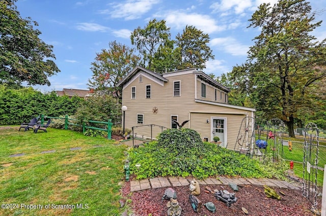 rear view of property featuring a yard