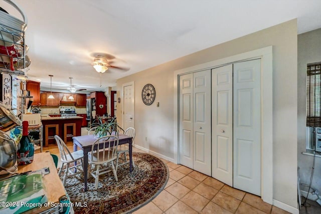 tiled dining room featuring ceiling fan