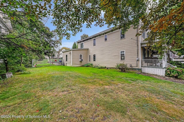 rear view of house featuring a lawn